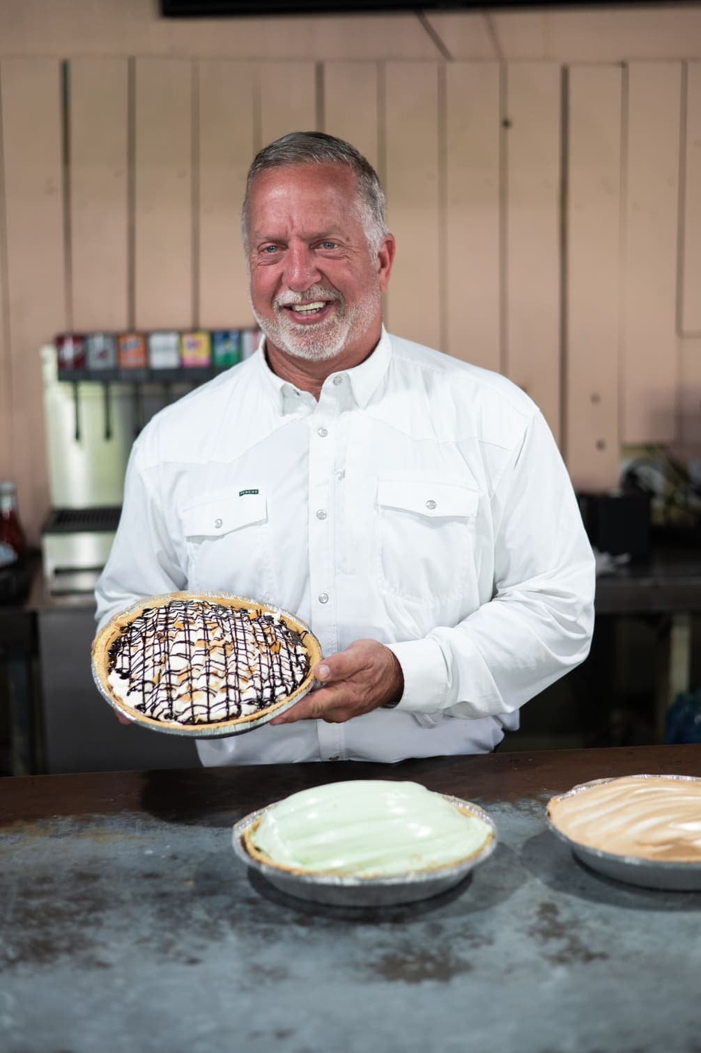 Owner Brian Koerselman holding a freshly made chocolate drizzle pie at Farmhouse Cafe